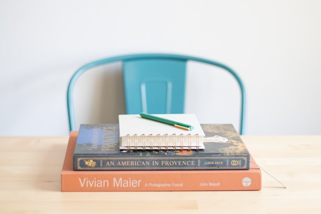 Croatian mystery novelist sitting at a wooden desk with a notebook