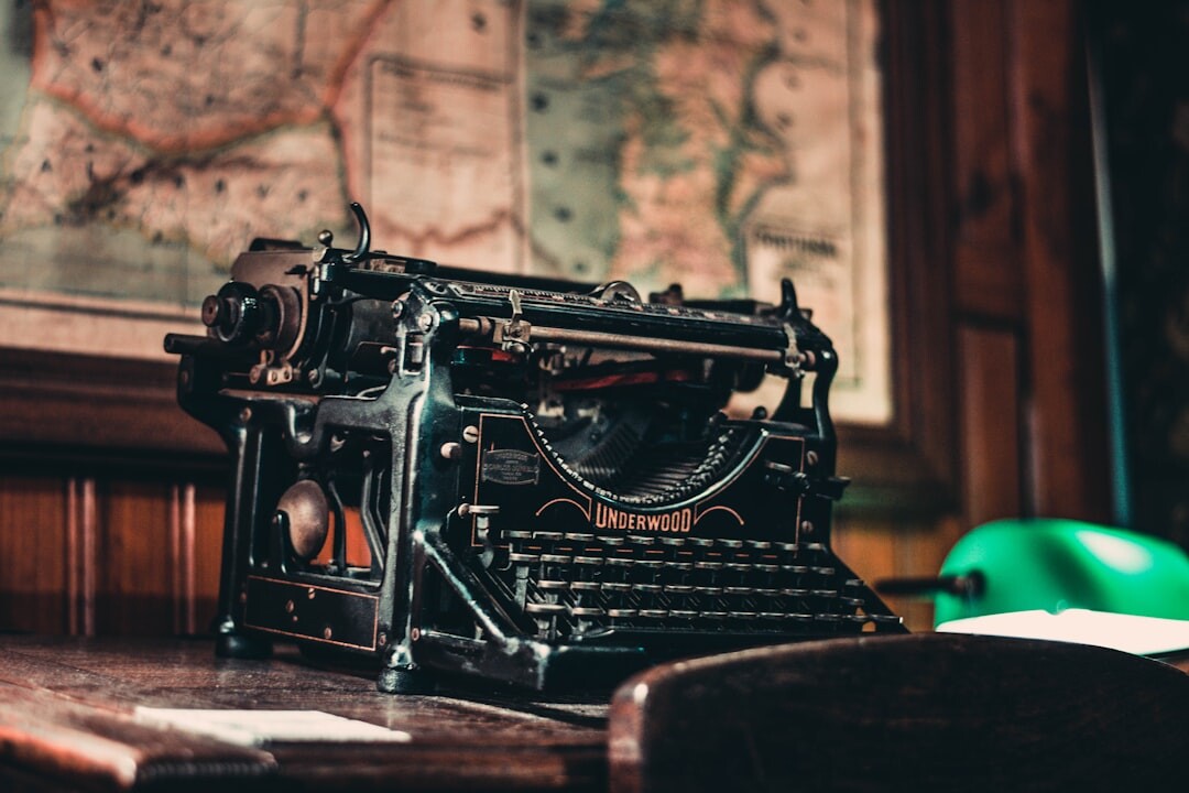 Vintage typewriter on a wooden desk with old letters and a magnifying glass